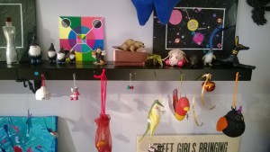 girl cave art shelves with paintings, ornaments, and bells