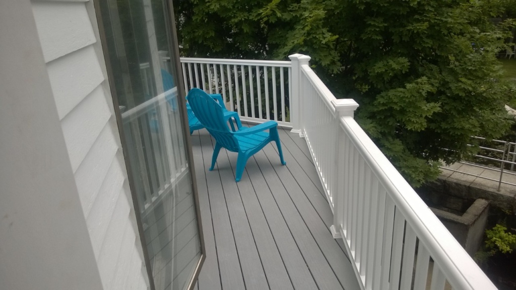 blue plastic adirondack chairs on deck