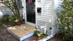 new wooden front stoop which replaced the crumbling brick one