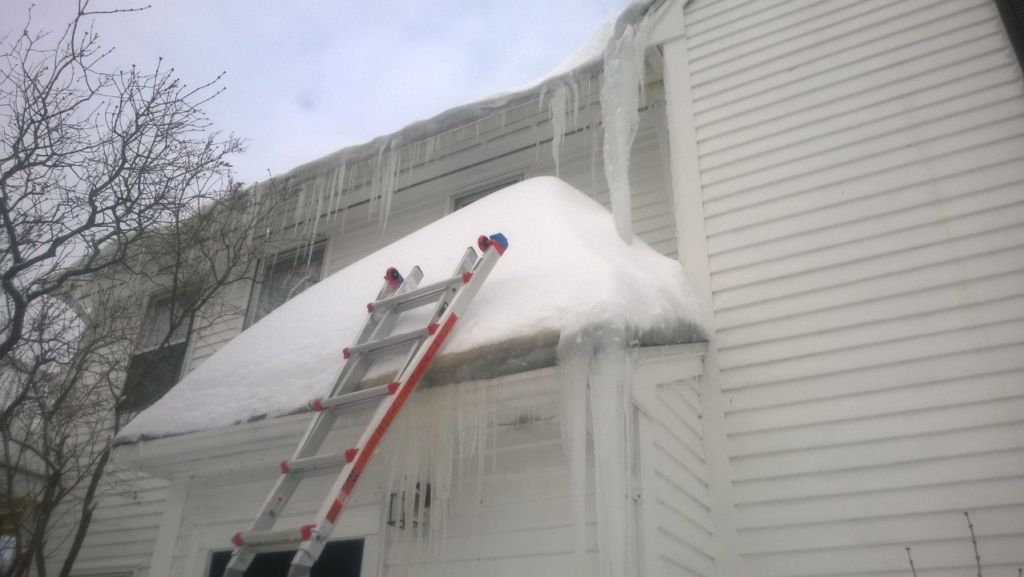 shoveling the front entranceway roof during snowmageddon 2015