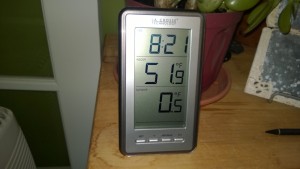 indoor/outdoor thermometer in living room showing 52 degrees