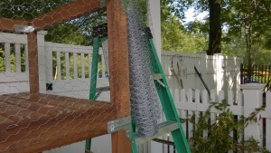 outdoor cat enclosure / catio stapling on the chicken wire