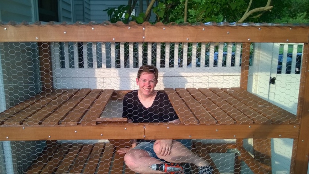 me sitting inside the outdoor cat enclosure / catio, installing ramps!