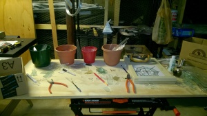 working on stained glass in the basement workshop cage