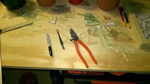 working on stained glass in the basement workshop cage