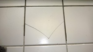 fixing the cracked tile in the master bathroom