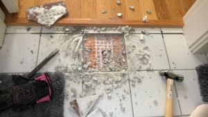fixing the cracked tile in the master bathroom / removing the old tile