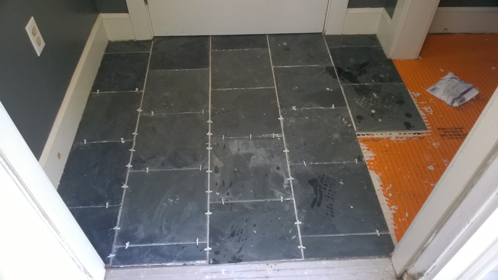 laying slate tiles in the front entrance hall
