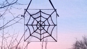 diy stained glass spider web hanging in living room window
