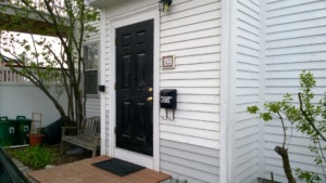 our front door after 1 coat of black semi-gloss behr paint