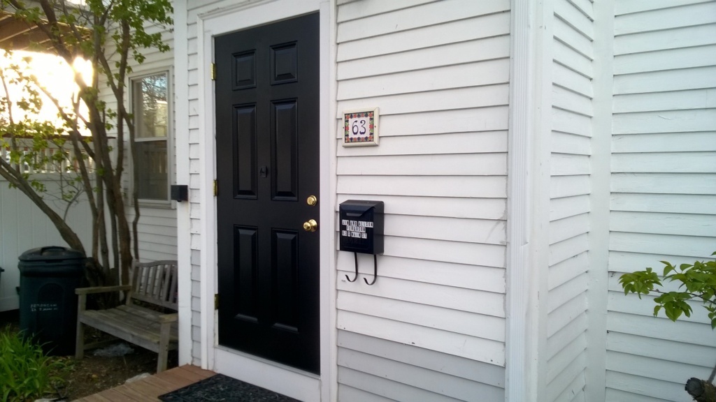 our front door after 3 coats of black semi-gloss behr paint