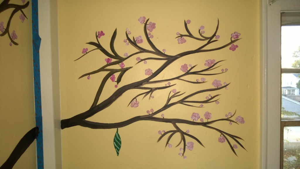 i painted butterfly chrysalis hanging from the cherry blossom tree on abbie's wall