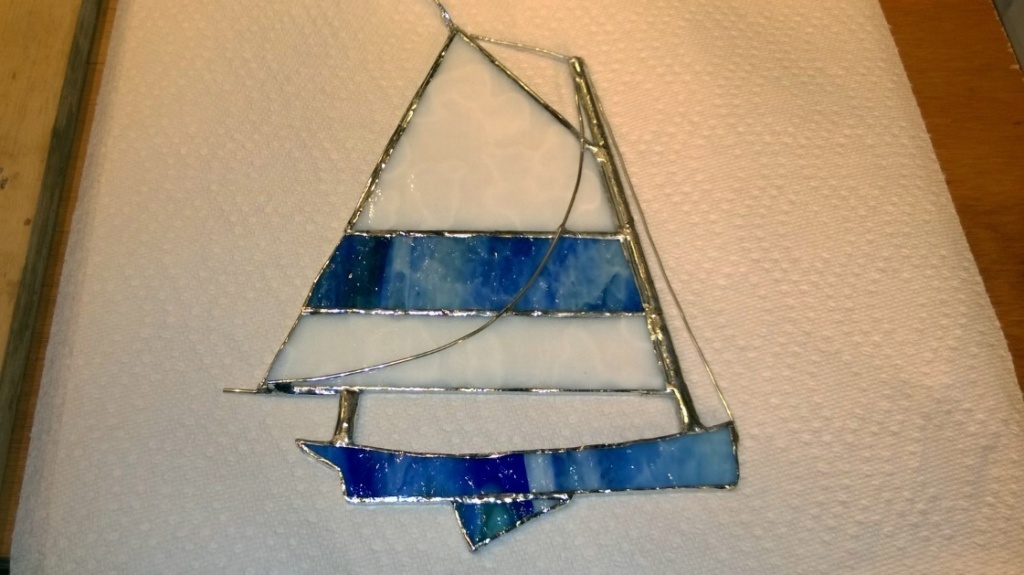 i added thin metal wire rigging to the stained glass sailboat