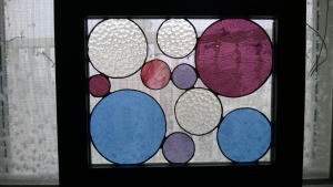 stained glass circles panel with snow in background
