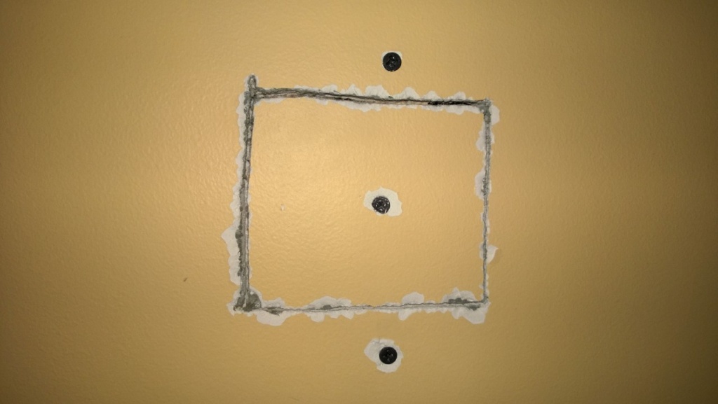 i screwed the drywall patch into the shim i'd placed inside the wall