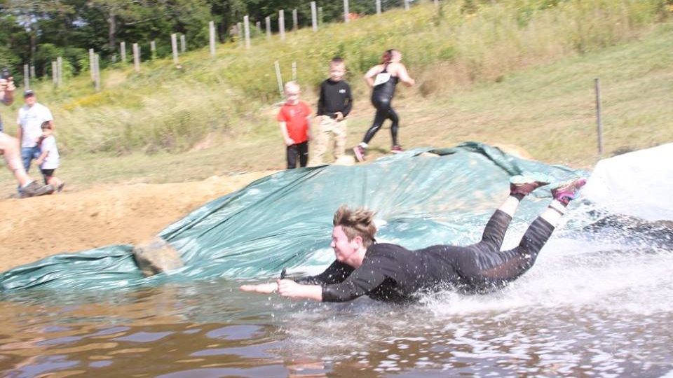 me completing the funnest obstacle at the 5k muddy leprechaun mud run - marini farm, ispwich!