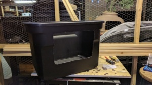 i cut a hole in the front of this black storage bin create a diy litterbox