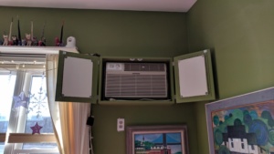 the completed ac box cover in the living room with doors open