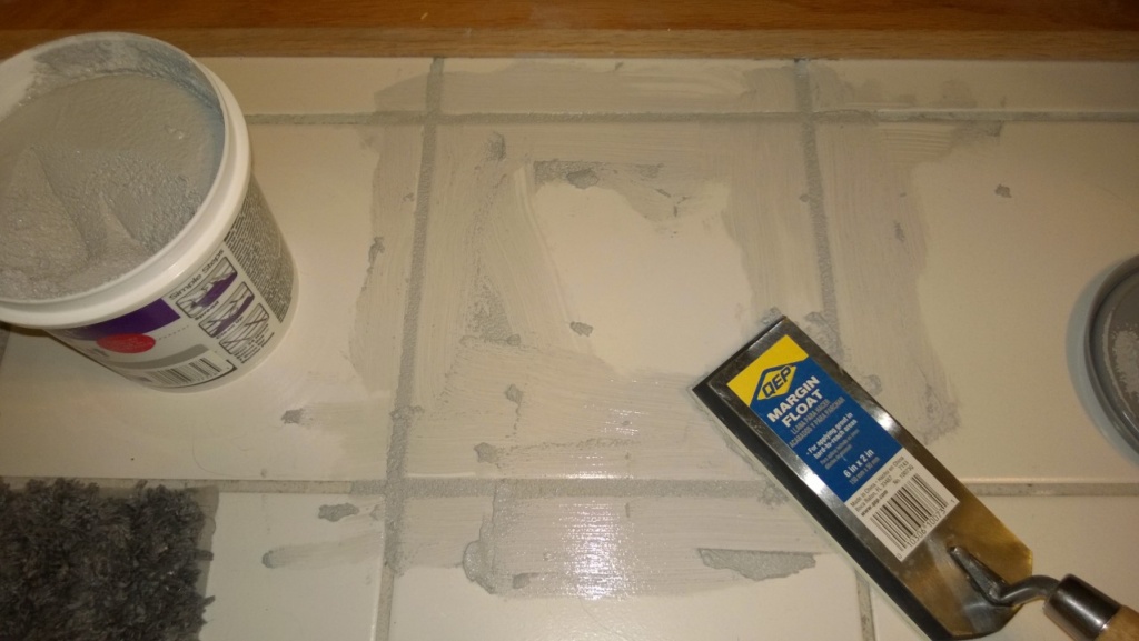 grouting the replacement tile in the master bathroom