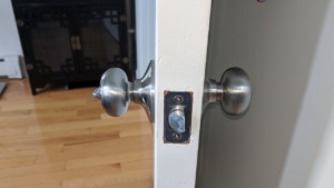 the silver nickel colored doorknob in the master bedroom/bath door