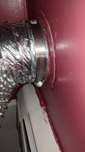 new dryer vent tube attached to wall vent with clamp