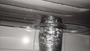 new dryer vent tube attached to dryer with clamp