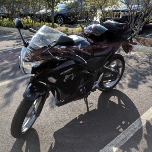 my honda cbr250 black motorcycle with hello kitty stickers