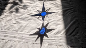 the completed blue nautical stained glass star reflected on our bed