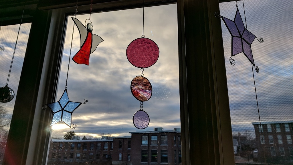 i hung the purple stained glass mobile in the living room window