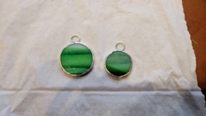 i soldered rings onto 2 circles of green glass for necklaces