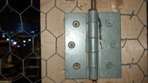 attaching hinges to the basement cage door