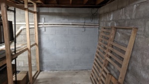 one coat of grey drylok waterproofing sealant on the basement wall
