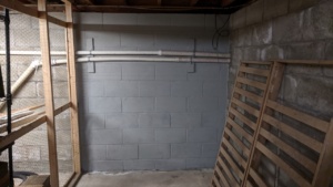 two coats of grey drylok waterproofing sealant on the basement wall