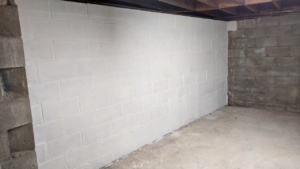 two coats of white drylok waterproofing sealant on the basement wall