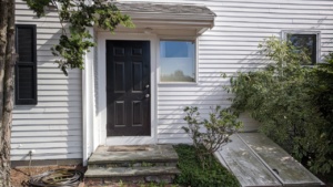 view of our back door and dirty basement bulkhead