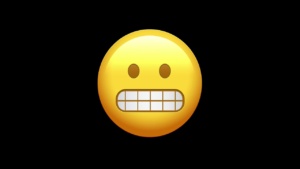 grimacing emoji on black background